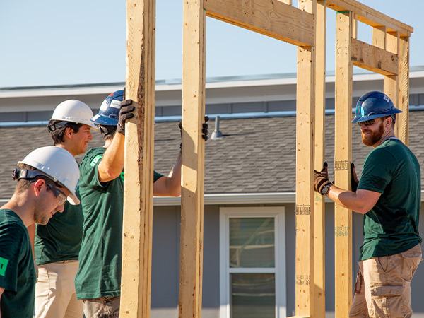 volunteers building homes