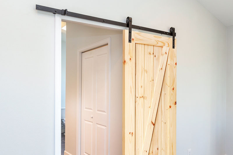 Save space with the modern farmhouse look of sliding barn doors.